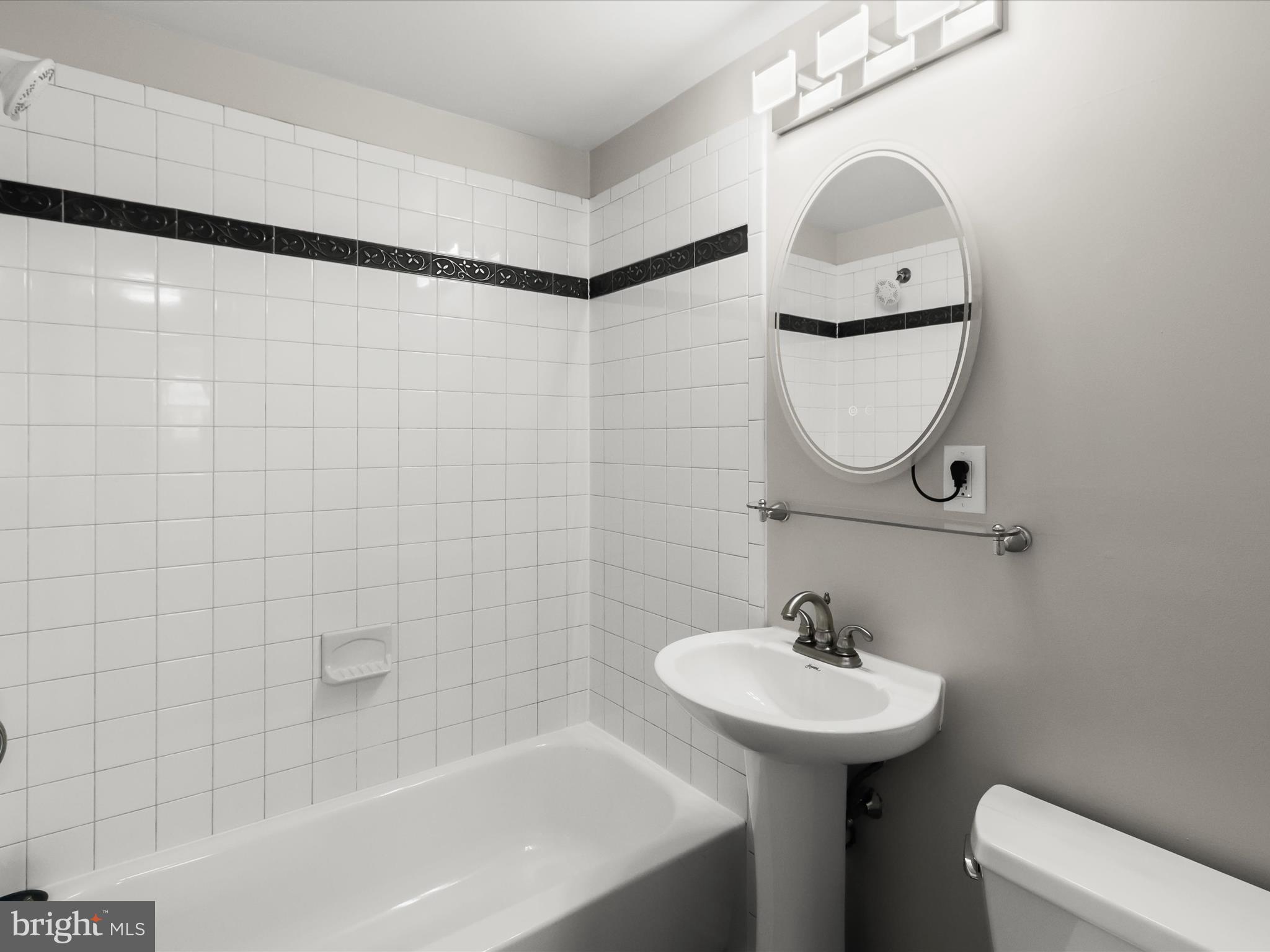 1026 Circle Drive Halethorpe, MD 21227 - Photo 25 of 37 a bathroom with a sink a toilet and shower