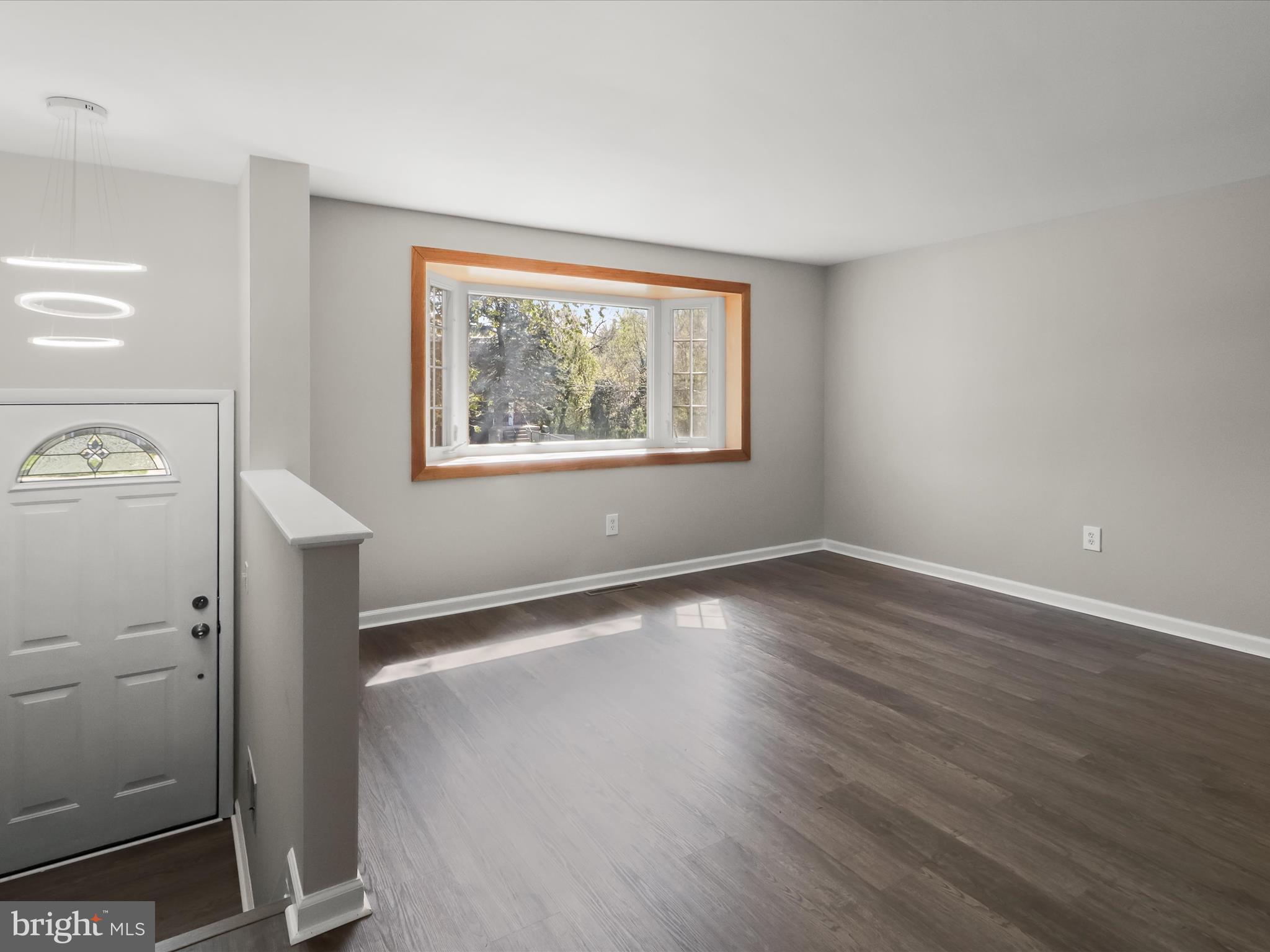 1026 Circle Drive Halethorpe, MD 21227 - Photo 7 of 37 an empty room with wooden floor and window