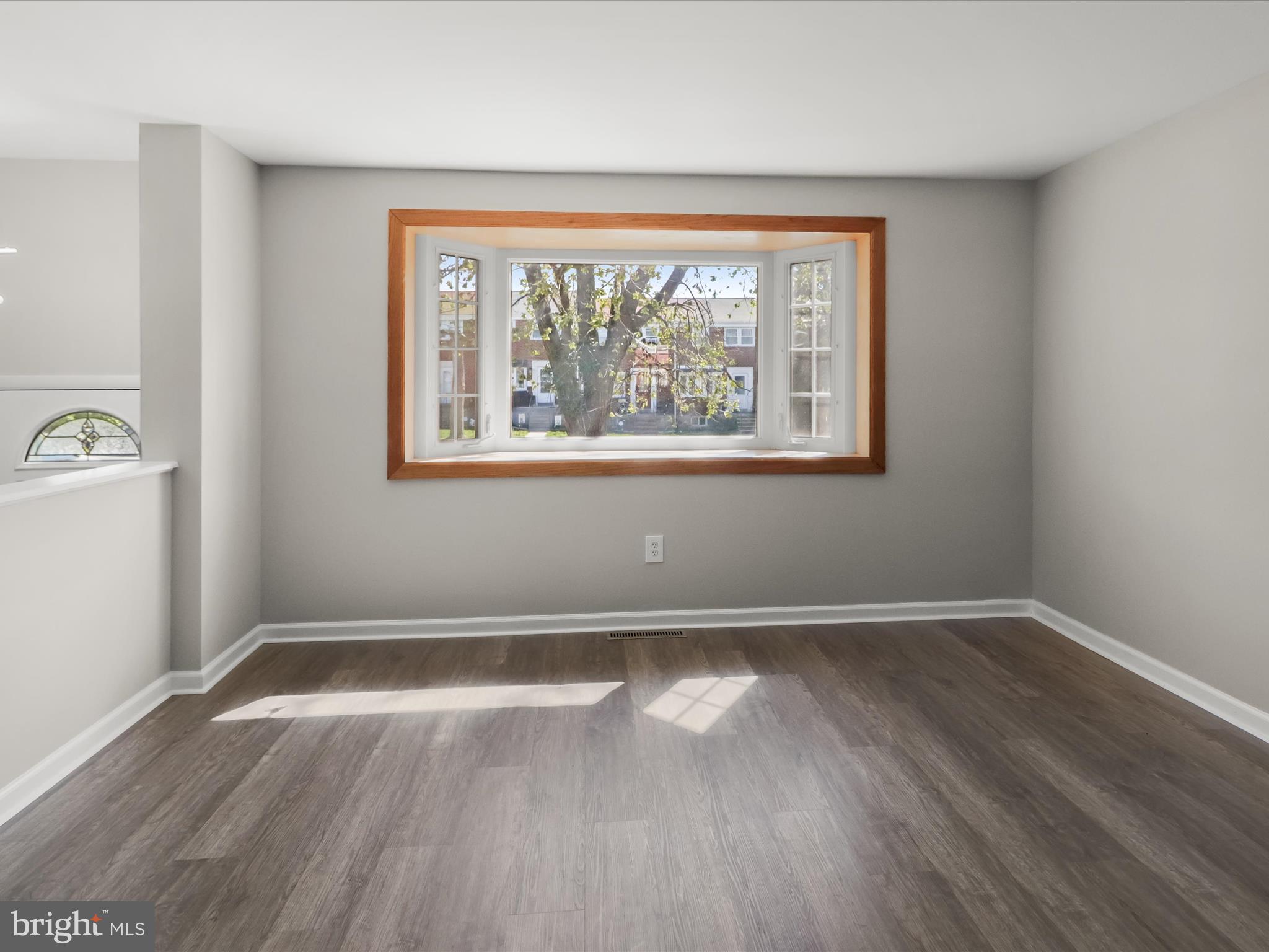 1026 Circle Drive Halethorpe, MD 21227 - Photo 8 of 37 an empty room with wooden floor and windows