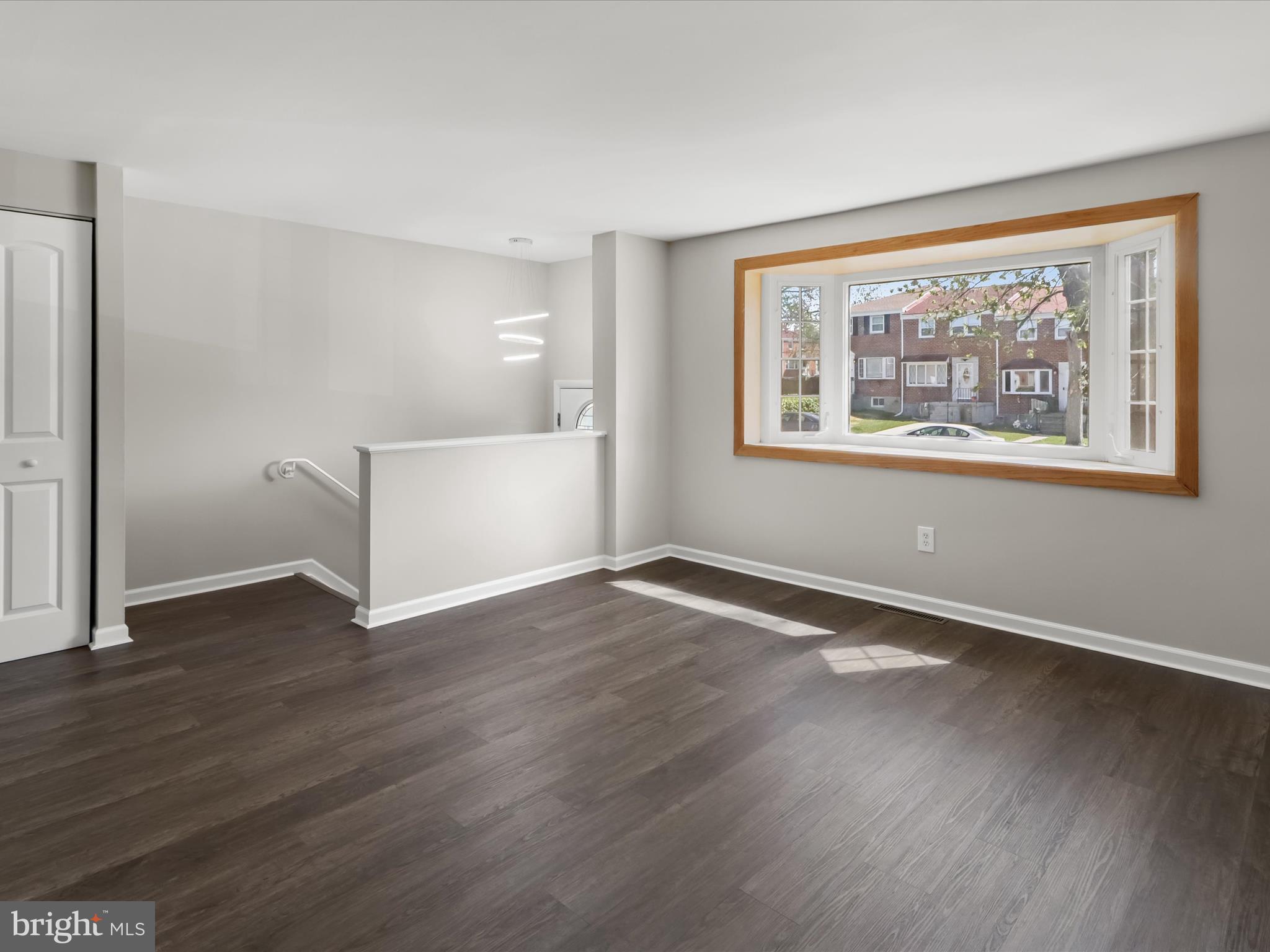 1026 Circle Drive Halethorpe, MD 21227 - Photo 9 of 37 an empty room with wooden floor and windows