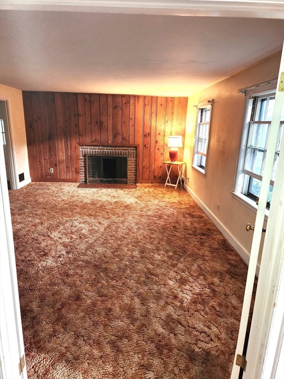 92 Lexington Road Billerica, MA 01821 - Photo 2 of 10 a view of an empty room with a fireplace and a window