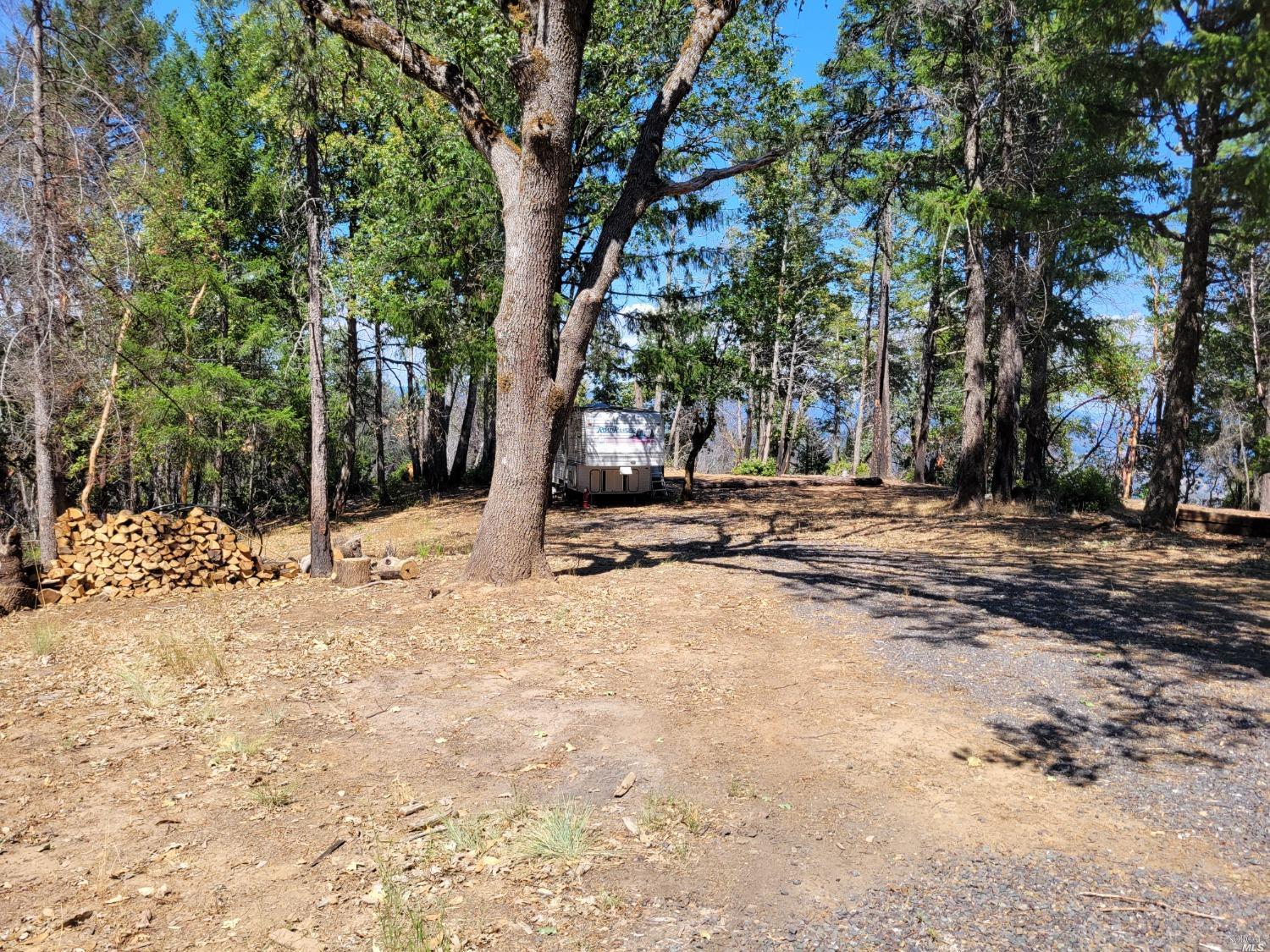 a view of snow on the side of road and trees