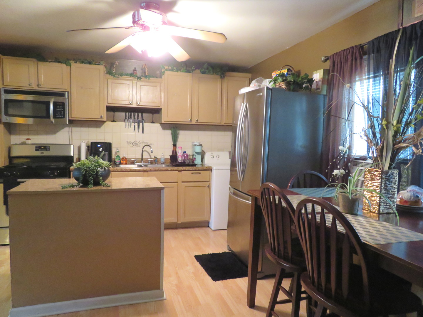 3305 Ridgewood Drive Champaign, IL 61821 - Photo 5 of 11 a kitchen with stainless steel appliances granite countertop a refrigerator a stove a sink dishwasher and white cabinets with wooden floor