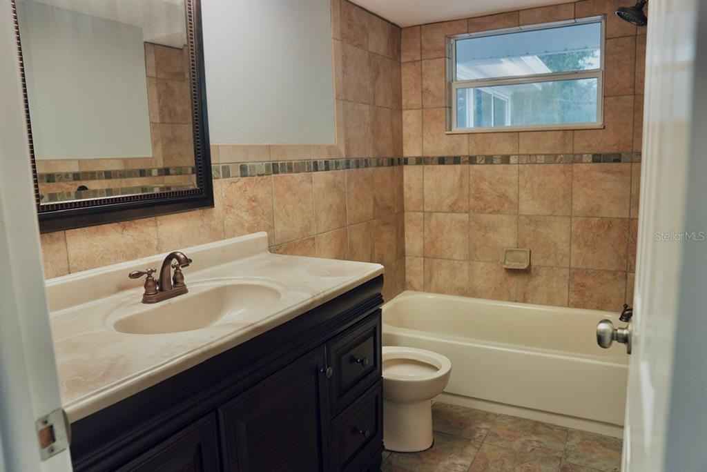 7944 Yucca Drive New Port Richey, FL 34653 - Photo 12 of 26 a bathroom with a sink and a mirror