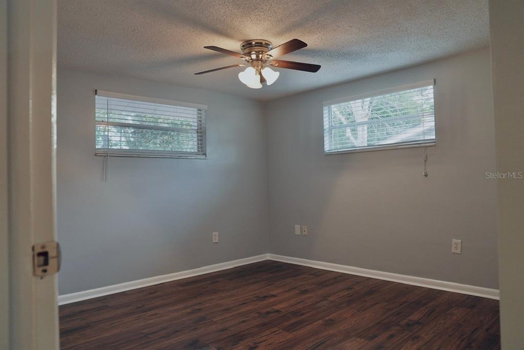 7944 Yucca Drive New Port Richey, FL 34653 - Photo 13 of 26 a view of an empty room with wooden floor