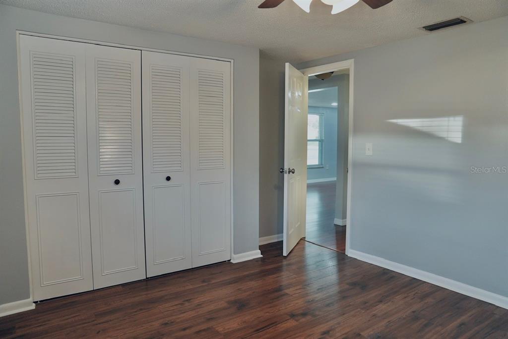 7944 Yucca Drive New Port Richey, FL 34653 - Photo 14 of 26 a view of an empty room with wooden floor and closet