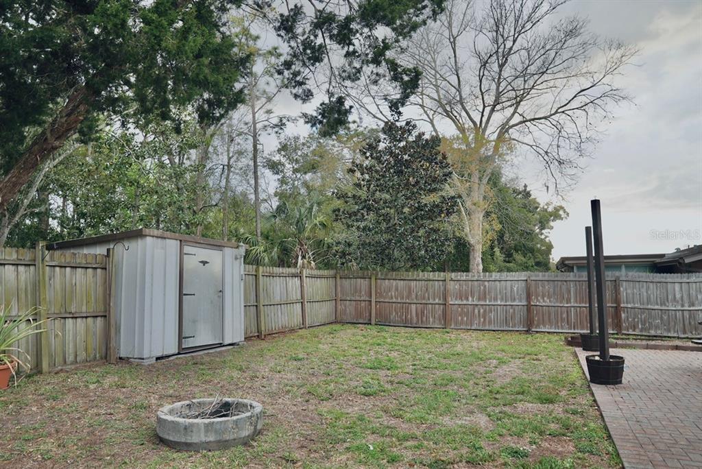 7944 Yucca Drive New Port Richey, FL 34653 - Photo 22 of 26 a view of a backyard with wooden fence