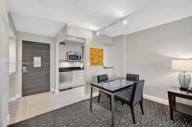 a bedroom with a large bed and a flat screen tv