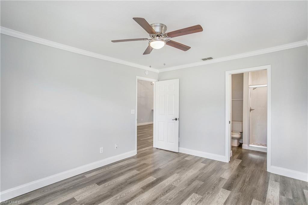 209 Robin Hood Circle, Unit 5201 Naples, FL 34104 - Photo 18 of 30 a view of an empty room with wooden floor
