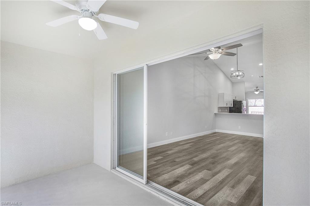 209 Robin Hood Circle, Unit 5201 Naples, FL 34104 - Photo 20 of 30 wooden floor in an empty room with a window