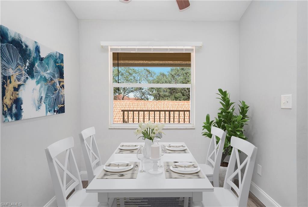 209 Robin Hood Circle, Unit 5201 Naples, FL 34104 - Photo 2 of 30 a view of a dining room with furniture window and wooden floor