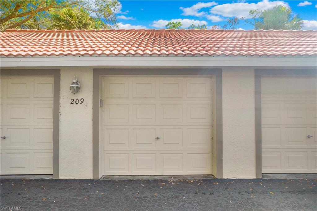 209 Robin Hood Circle, Unit 5201 Naples, FL 34104 - Photo 24 of 30 a front view of a building