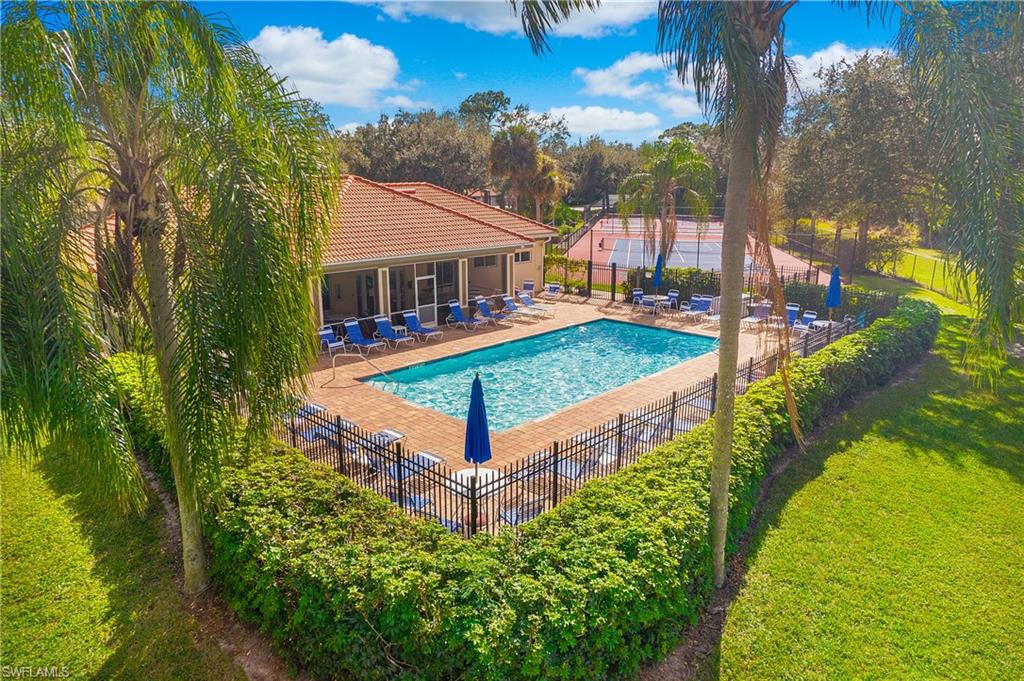 209 Robin Hood Circle, Unit 5201 Naples, FL 34104 - Photo 25 of 30 a view of a small house in the middle of a yard