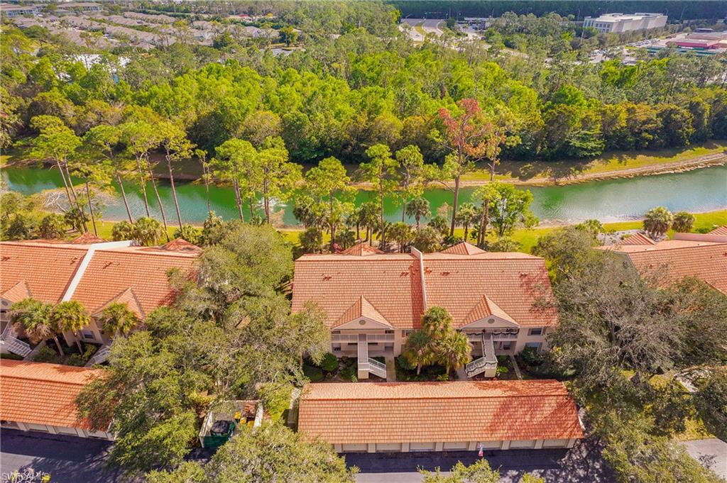 209 Robin Hood Circle, Unit 5201 Naples, FL 34104 - Photo 28 of 30 an aerial view of a house with a lake view