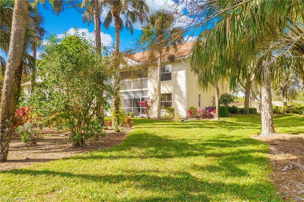 209 Robin Hood Circle, Unit 5201 Naples, FL 34104 - Photo 30 of 30 a garden with trees