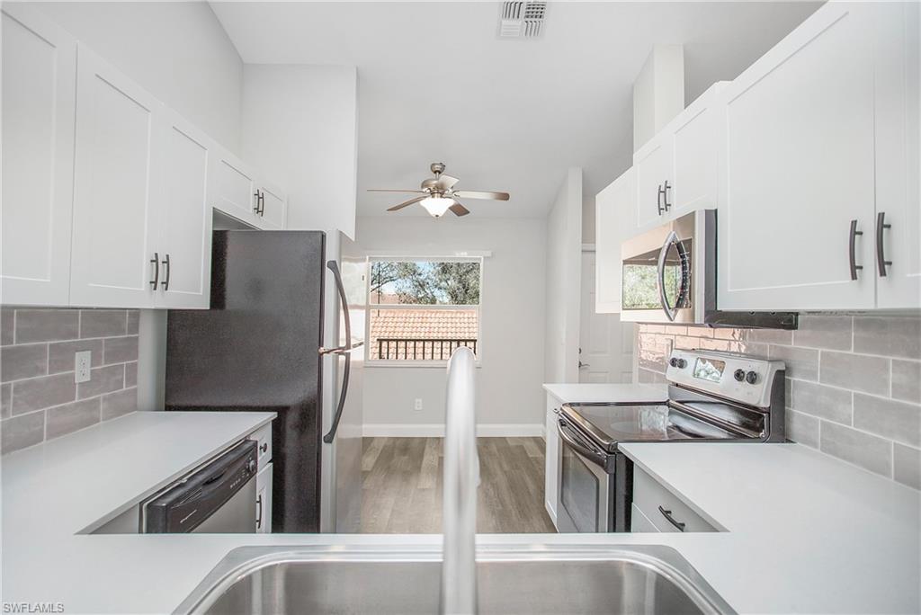 209 Robin Hood Circle, Unit 5201 Naples, FL 34104 - Photo 3 of 30 a kitchen with a sink stove and refrigerator