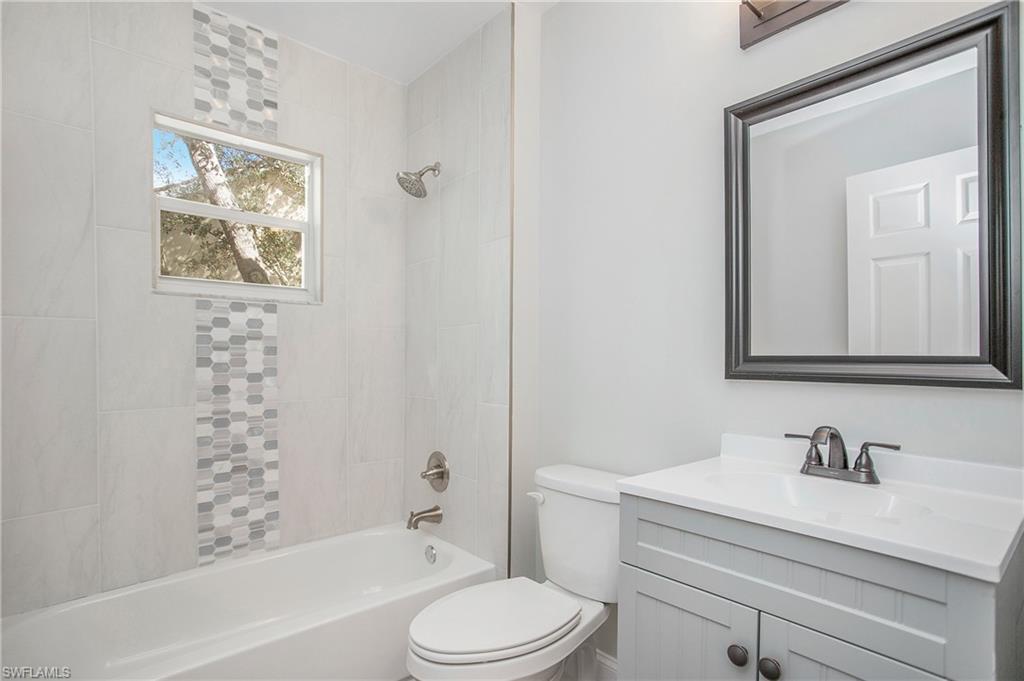 209 Robin Hood Circle, Unit 5201 Naples, FL 34104 - Photo 6 of 30 a bathroom with a sink vanity mirror and toilet
