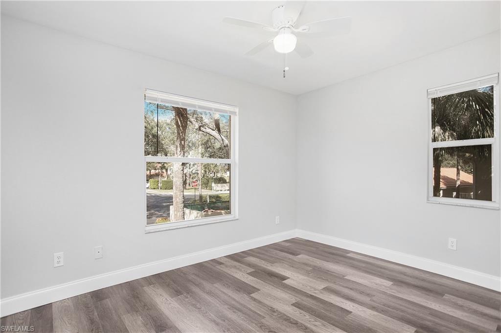 209 Robin Hood Circle, Unit 5201 Naples, FL 34104 - Photo 7 of 30 an empty room with windows and closet