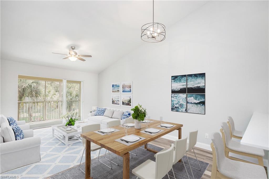 209 Robin Hood Circle, Unit 5201 Naples, FL 34104 - Photo 10 of 30 a living room with furniture and a large window