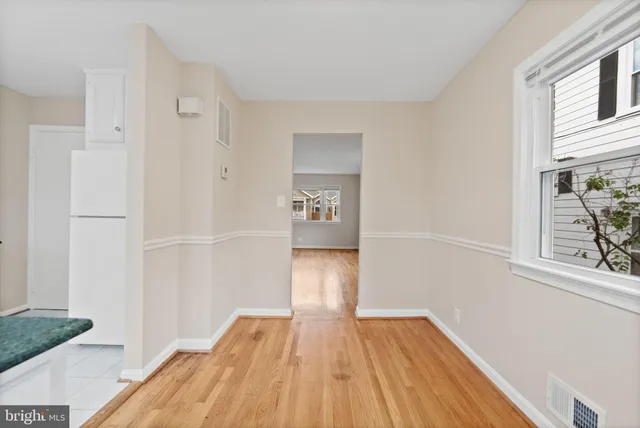 a kitchen with granite countertop a refrigerator and a sink