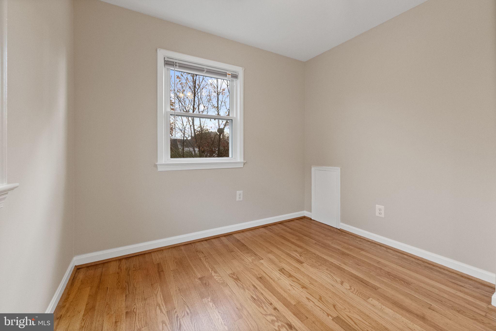 107 East Del Ray Avenue Alexandria, VA 22301 - Photo 23 of 30 wooden floor in an empty room with a window