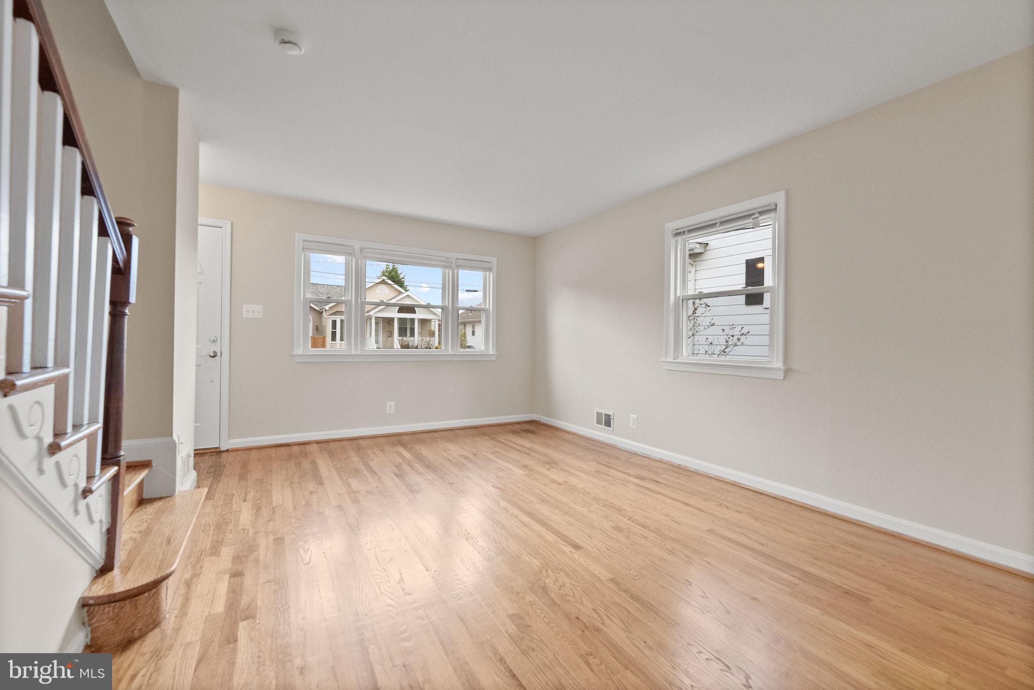 107 East Del Ray Avenue Alexandria, VA 22301 - Photo 24 of 30 an empty room with wooden floor and windows