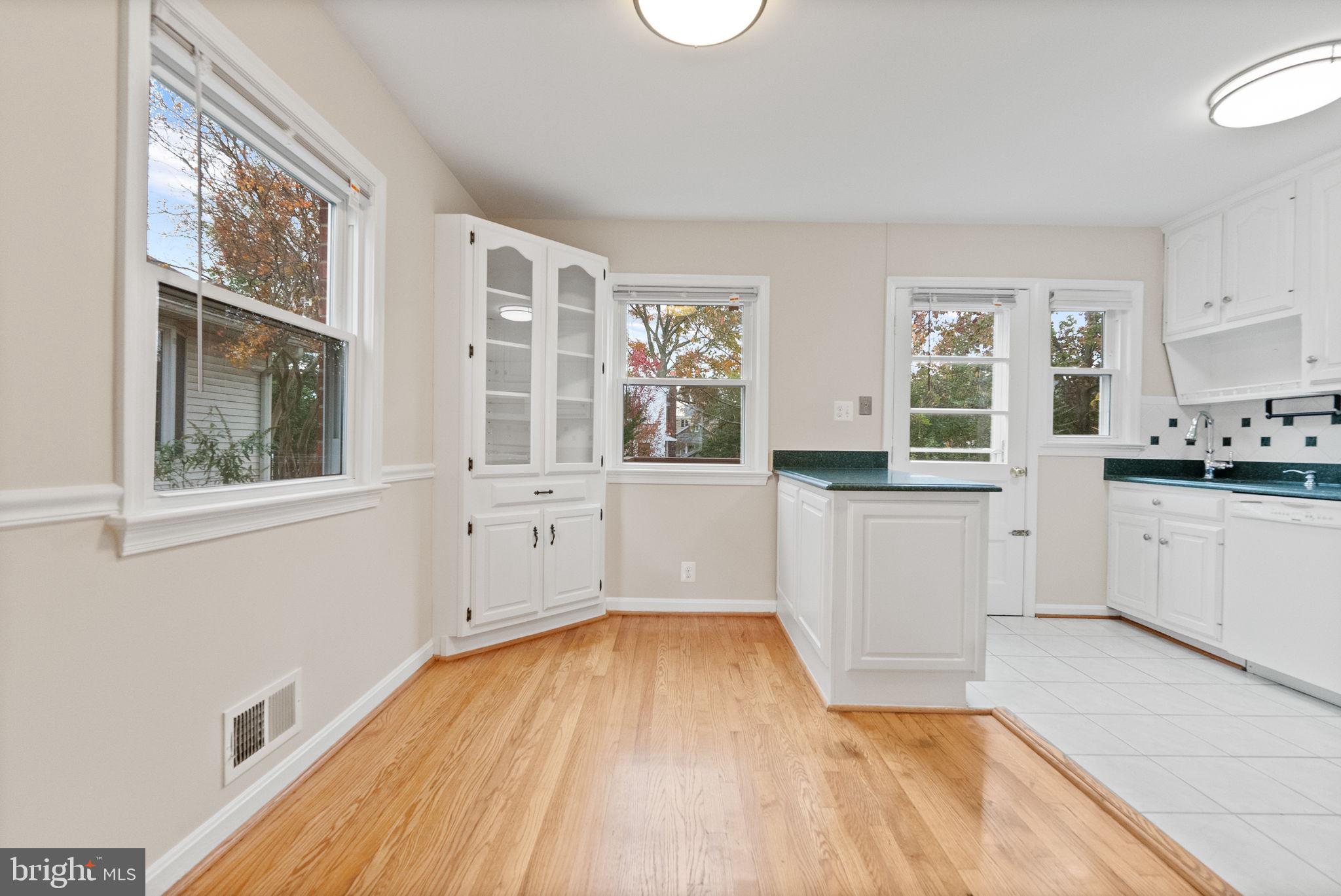 107 East Del Ray Avenue Alexandria, VA 22301 - Photo 27 of 30 a view of a kitchen with wooden floor and electronic appliances