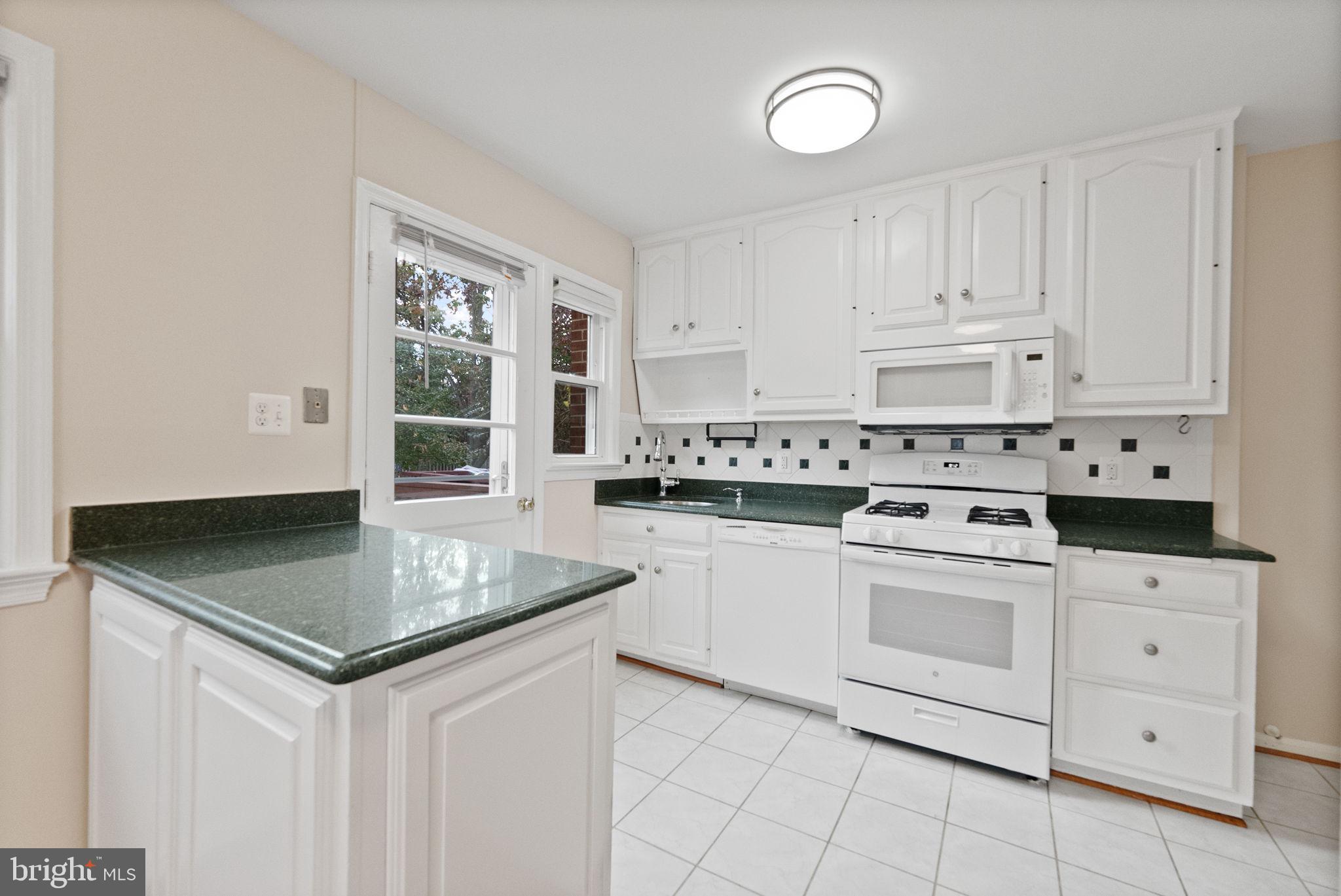 107 East Del Ray Avenue Alexandria, VA 22301 - Photo 28 of 30 a kitchen with granite countertop a sink appliances and cabinets