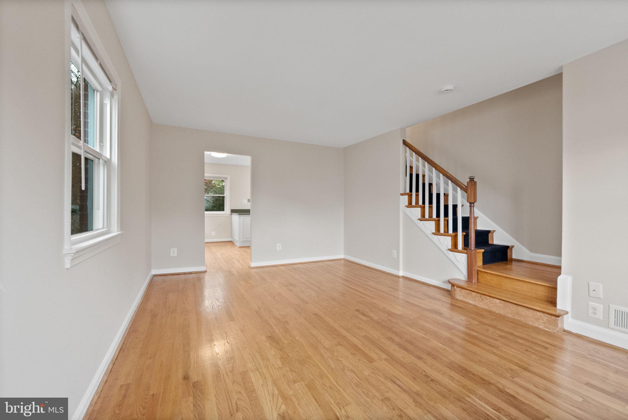 107 East Del Ray Avenue Alexandria, VA 22301 - Photo 4 of 30 a view of empty room with wooden floor and stairs