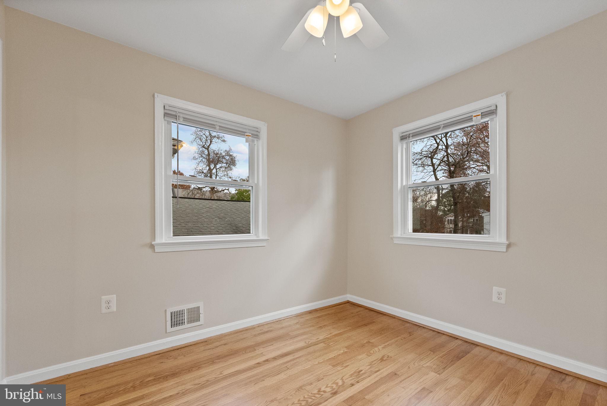 107 East Del Ray Avenue Alexandria, VA 22301 - Photo 6 of 30 a view of an empty room with wooden floor and a window