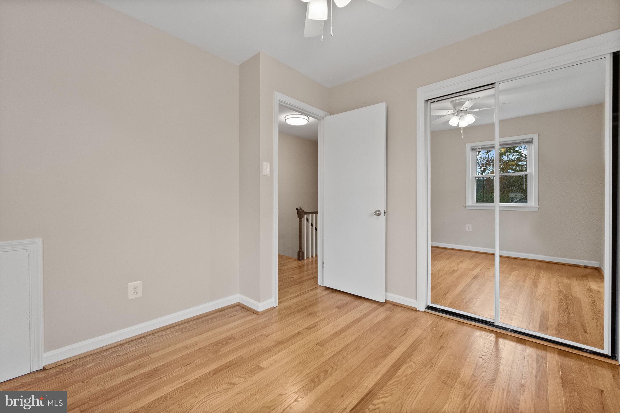 107 East Del Ray Avenue Alexandria, VA 22301 - Photo 7 of 30 an empty room with wooden floor and windows