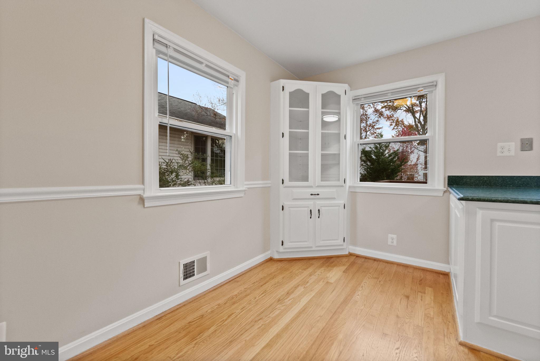 107 East Del Ray Avenue Alexandria, VA 22301 - Photo 8 of 30 wooden floor in an empty room with a window