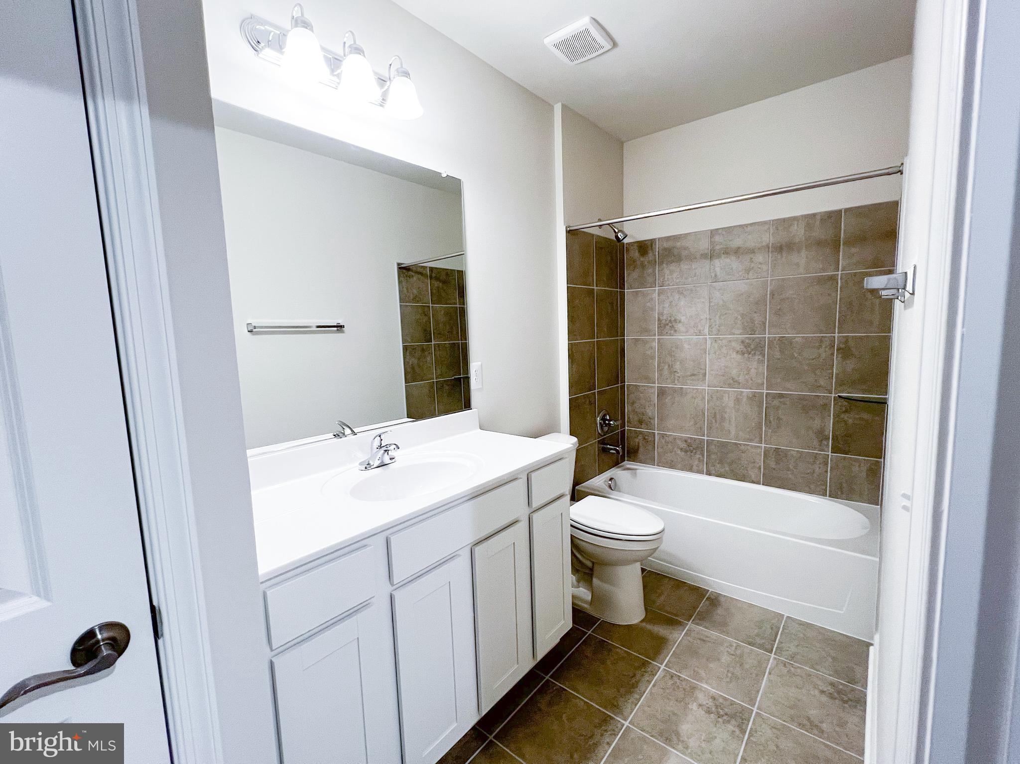 9204 Crestview Rdg Drive Bristow, VA 20136 - Photo 17 of 30 a bathroom with a double vanity sink toilet and shower