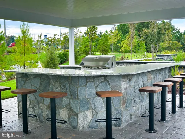 a kitchen with stainless steel appliances granite countertop a sink and a counter