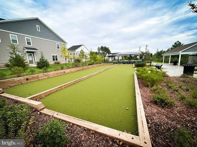 a view of a patio with table and chairs potted plants and a palm tree