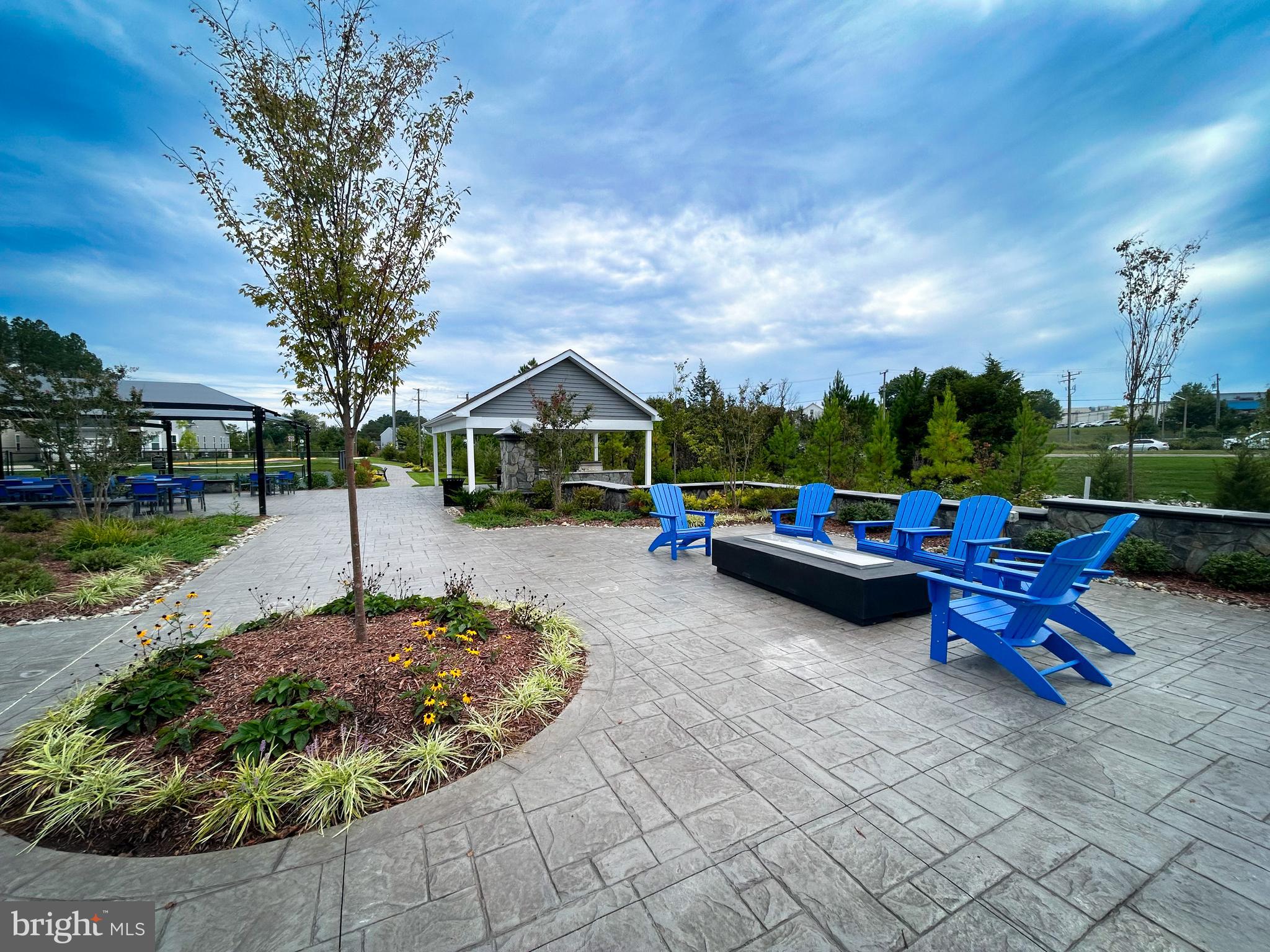 9204 Crestview Rdg Drive Bristow, VA 20136 - Photo 27 of 30 a view of a patio with table and chairs potted plants and a palm tree