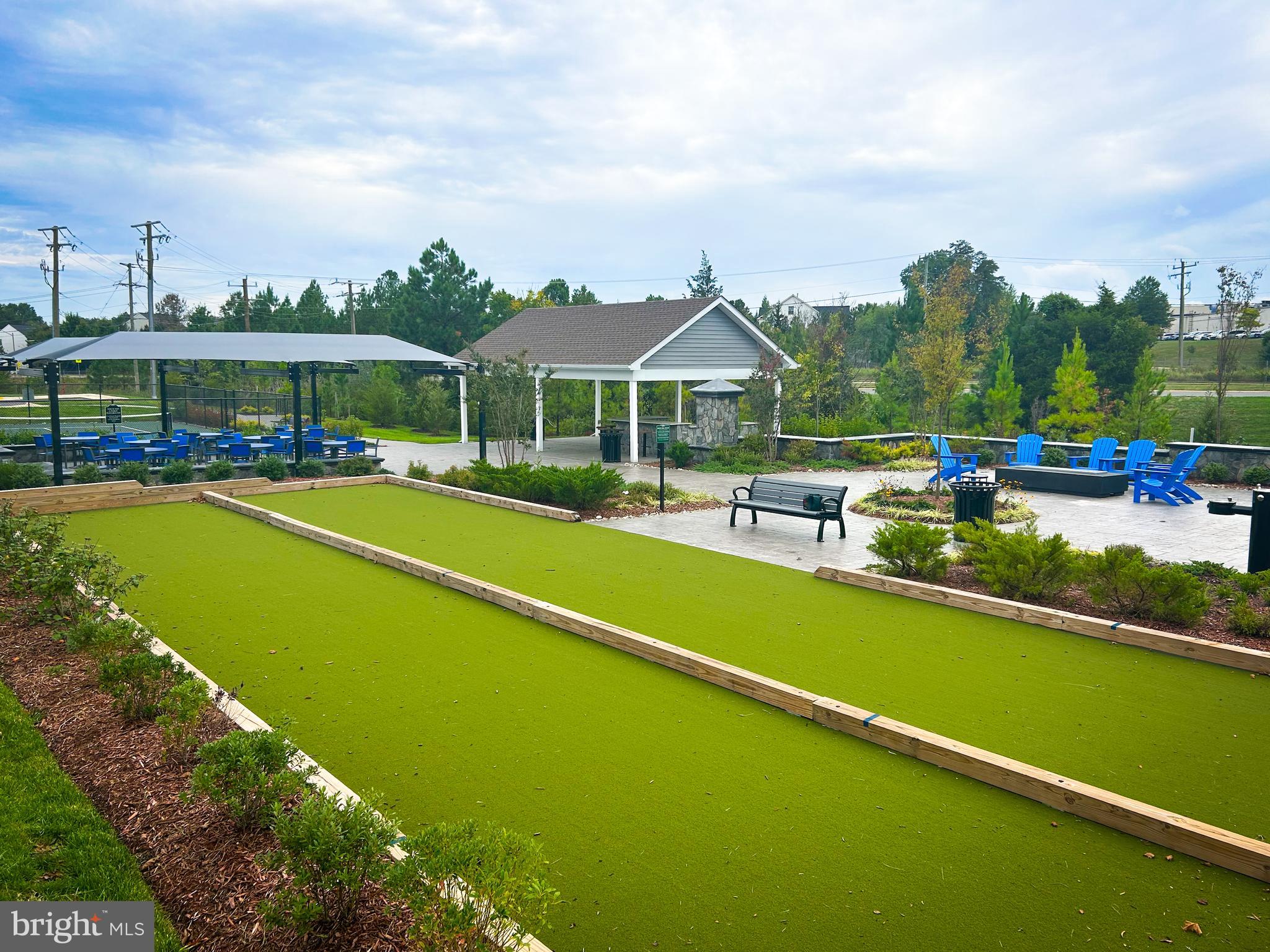 9204 Crestview Rdg Drive Bristow, VA 20136 - Photo 30 of 30 a view of a swimming pool with lawn chairs under an umbrella