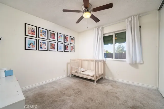 a living room with furniture and ceiling fan
