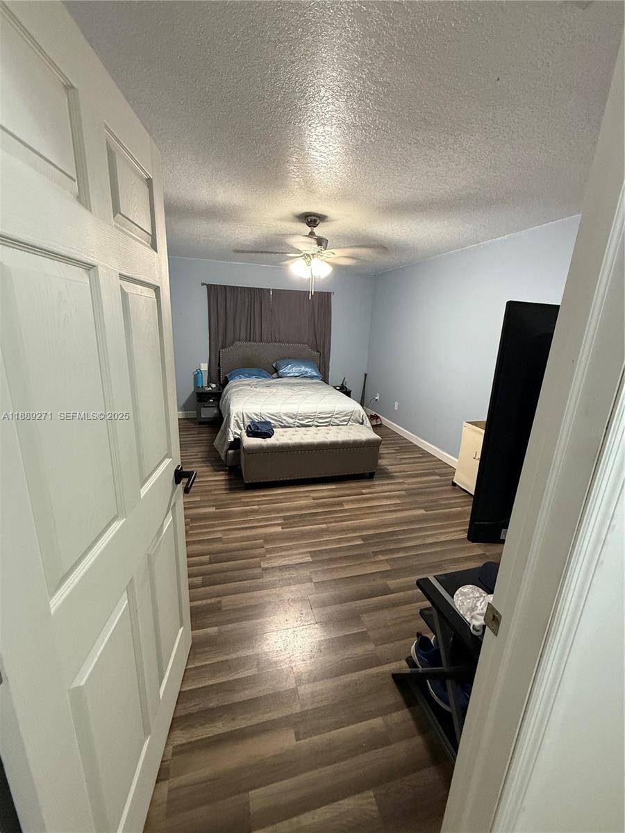 13060 Southwest 263rd Terrace Homestead, FL 33032 - Photo 19 of 30 a bedroom with a bed and a hallway