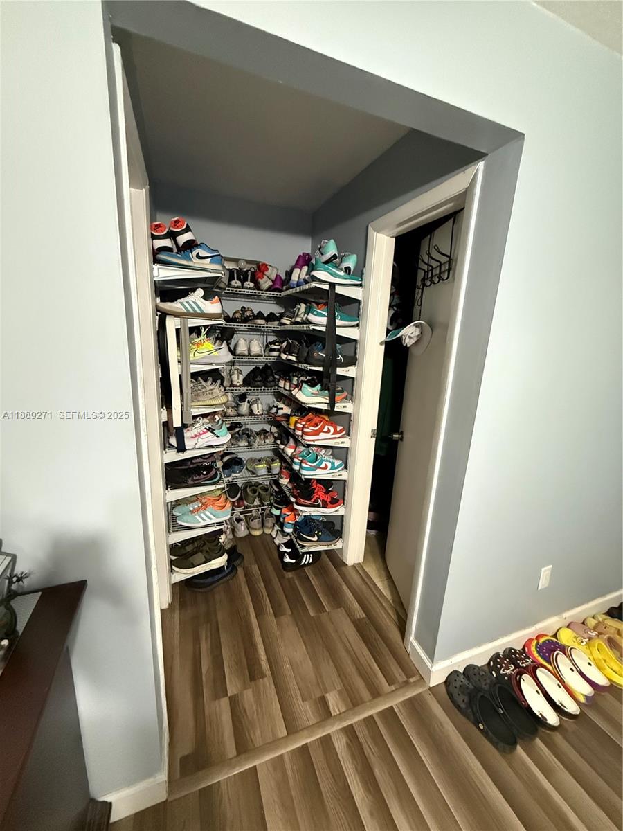 13060 Southwest 263rd Terrace Homestead, FL 33032 - Photo 20 of 30 a view of walk in closet with clothes and shoes