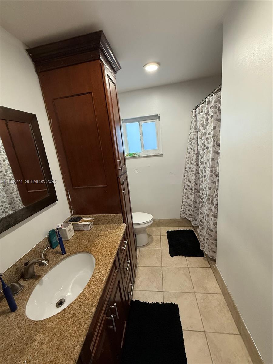 13060 Southwest 263rd Terrace Homestead, FL 33032 - Photo 22 of 30 a bathroom with a granite countertop sink and a mirror