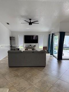 13060 Southwest 263rd Terrace Homestead, FL 33032 - Photo 28 of 30 a living room with couches and a flat screen tv with kitchen view