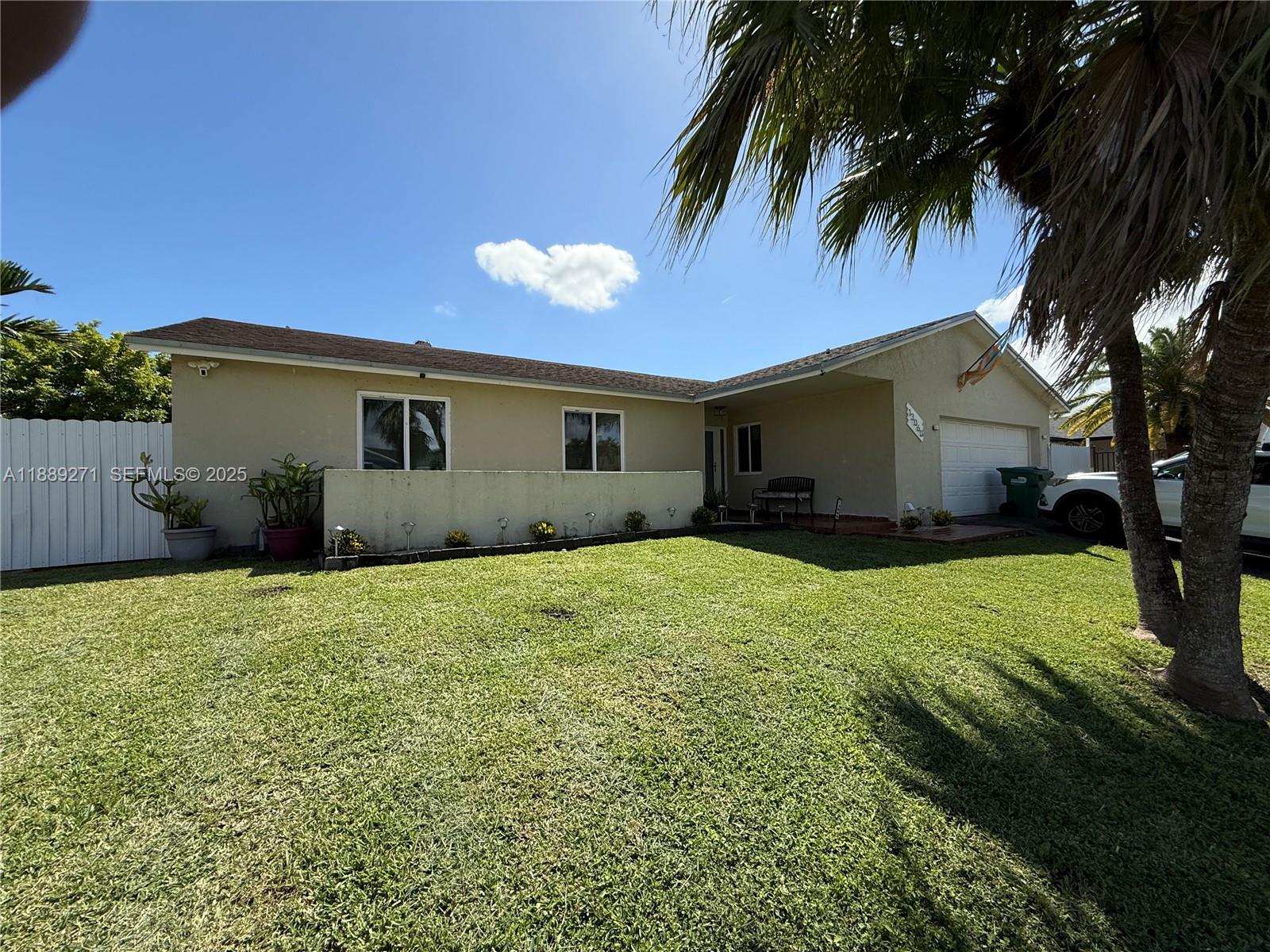 13060 Southwest 263rd Terrace Homestead, FL 33032 - Photo 5 of 30 a house view with a garden space