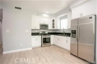 a kitchen with stainless steel appliances granite countertop a sink a stove and microwave