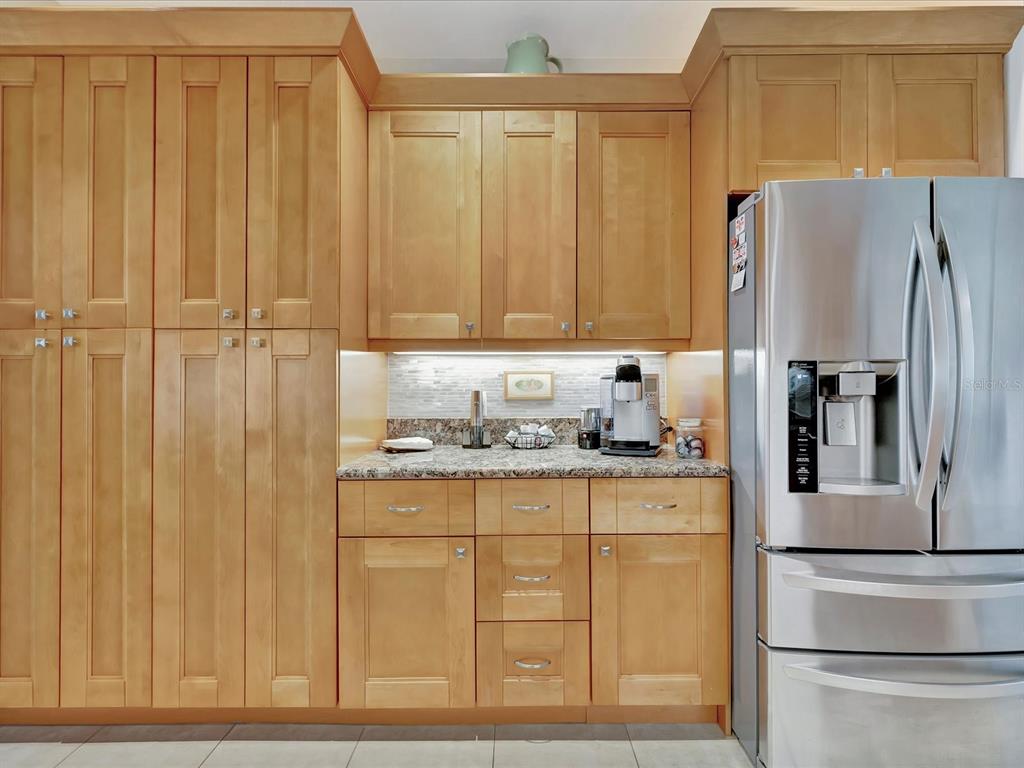 1022 Bellasol Way, Unit 5302 Apollo Beach, FL 33572 - Photo 11 of 43 a kitchen with stainless steel appliances granite countertop a refrigerator and a stove top oven