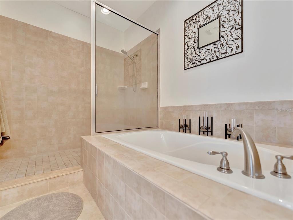1022 Bellasol Way, Unit 5302 Apollo Beach, FL 33572 - Photo 23 of 43 a bathroom with a tub a sink and a shower