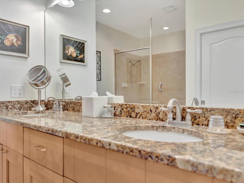 1022 Bellasol Way, Unit 5302 Apollo Beach, FL 33572 - Photo 25 of 43 a bathroom with a granite countertop sink and a mirror