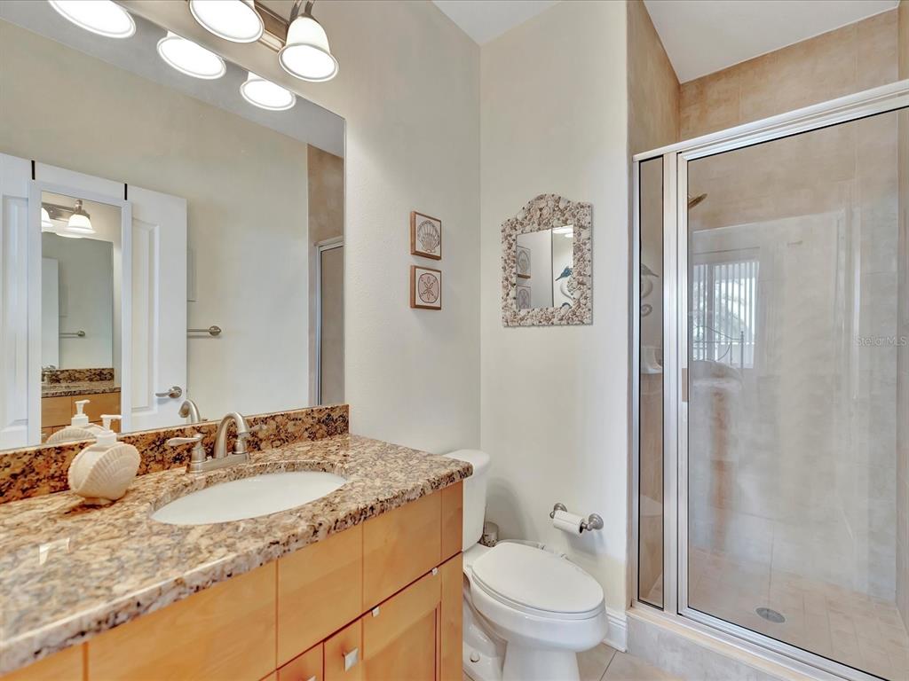 1022 Bellasol Way, Unit 5302 Apollo Beach, FL 33572 - Photo 5 of 43 a bathroom with a granite countertop sink toilet and shower