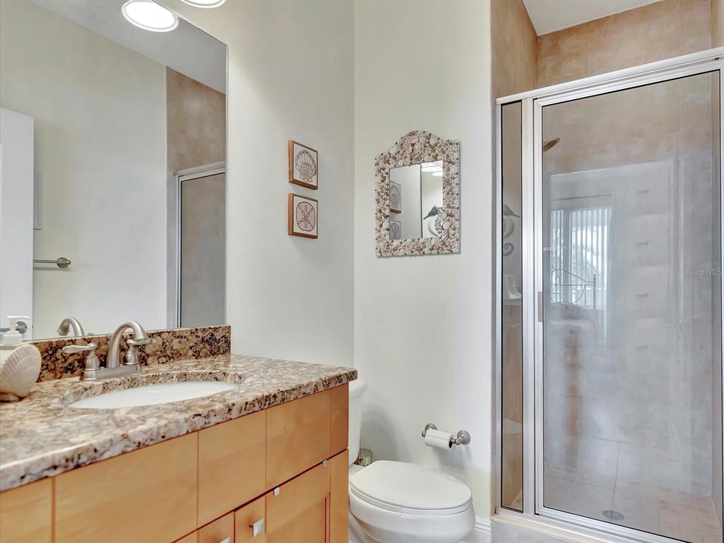 1022 Bellasol Way, Unit 5302 Apollo Beach, FL 33572 - Photo 6 of 43 a bathroom with a granite countertop sink toilet and shower