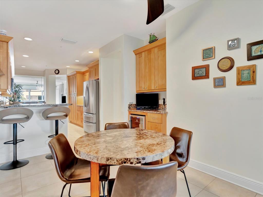 1022 Bellasol Way, Unit 5302 Apollo Beach, FL 33572 - Photo 9 of 43 a dining room with furniture and a flat screen tv